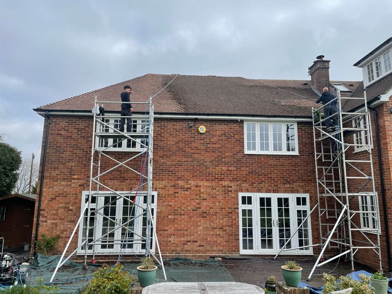 Roof cleaning carried out safely from scaffold towers by The Roof Moss Cleaners in Woodley